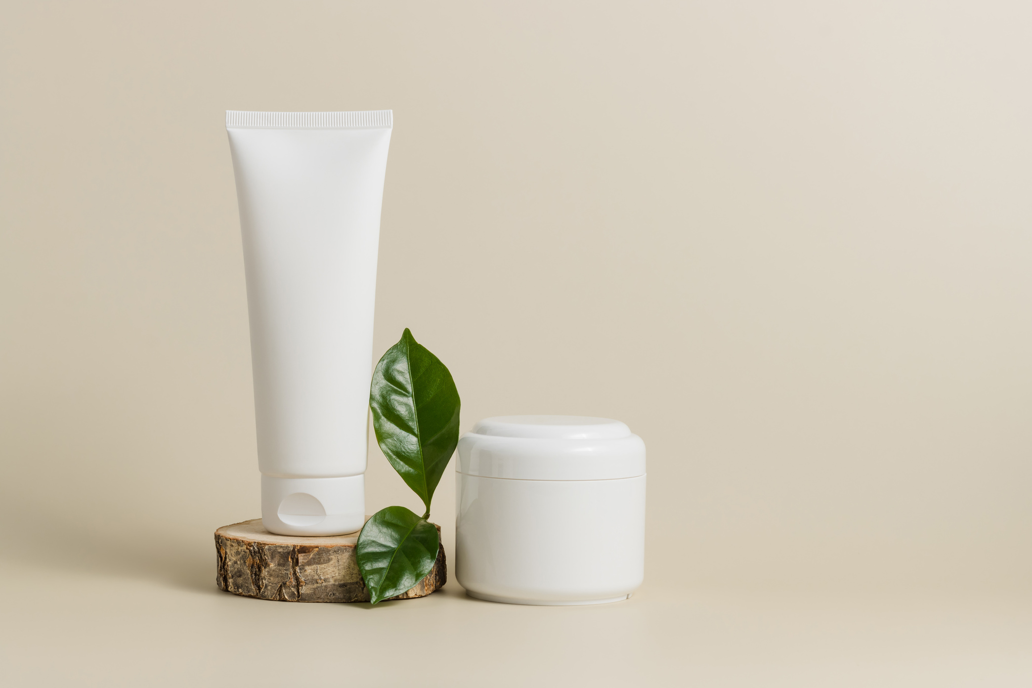 Mockup unbranded tube face cream on wooden stand with cream